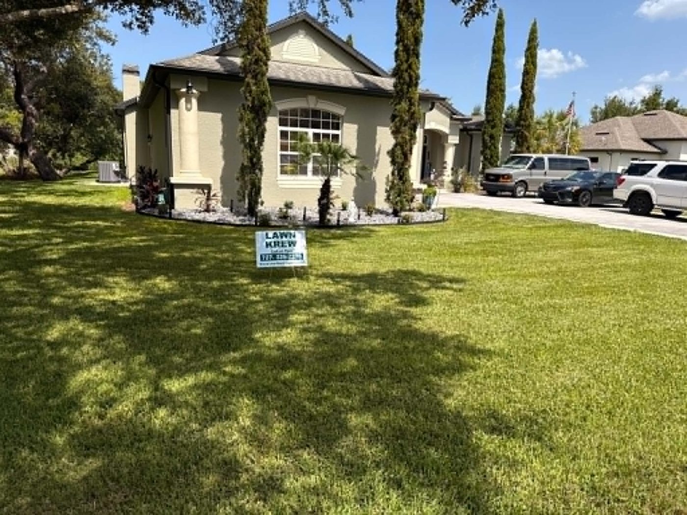 A Lawn Krew sign in a freshly maintained Spring Hill front yard